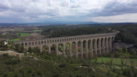 Back-aerial-traveling-over-the-largest-stone-aqueduct-in-the-world-Roquefavour